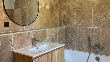 Standaard kamer | Badkamer | Een haardroger, handdoeken, zeep, shampoo