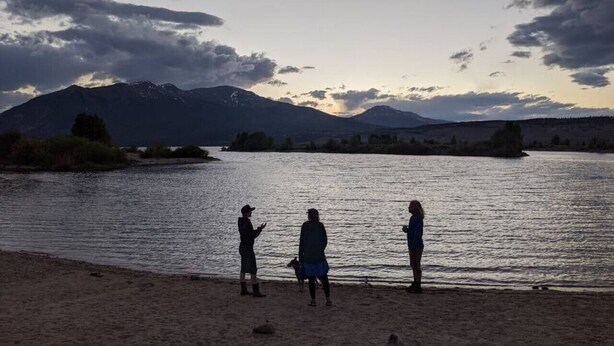 Three people standing by a lake with mountains in the background. - Stay Twin Lakes Cabin 4 (Twin Lakes)