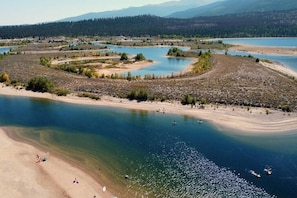 A river with clear water, sandy beach, and surrounding forest. - Stay Twin Lakes Cabin 4 (Twin Lakes)
