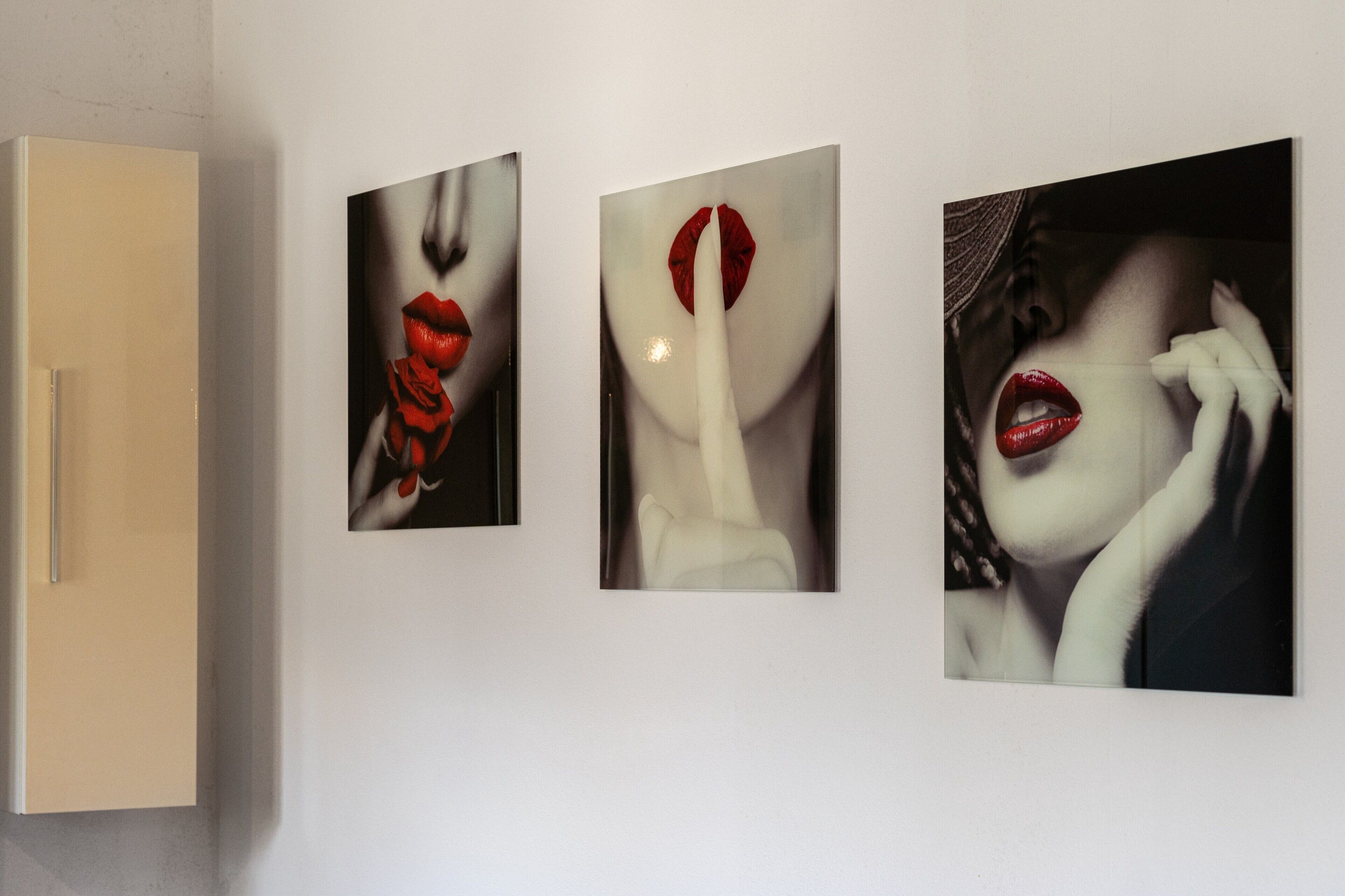 Three framed artworks on a wall.