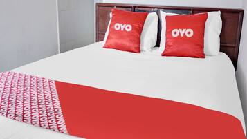 Laptop workspace, bed sheets