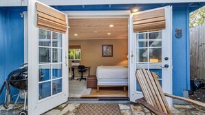 A compact room with a bed, a desk, and a chair, with a view of the outdoors. - 3875 The Hideout - Quiet Area, Walk to Town (Carmel-by-the-Sea)