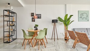 A modern living room with a dining area, a standing lamp, and a large plant. - '2-Bedroom Apartment with Seaview', Wi-Fi and Air Conditioning (Nerja)