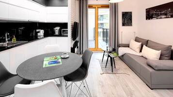 A modern apartment with a kitchen, dining area, and living room.