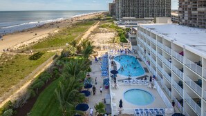A hotel with a rooftop pool, beach access, and ocean views.