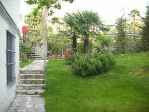 A stone staircase leading to a building with metal bars on the windows.