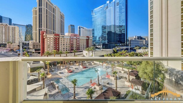 A hotel with a pool area, multiple high-rise buildings in the background, and a clear blue sky. - Las Vegas Suite | Jacuzzi, Balcony & Strip Views (Las Vegas)