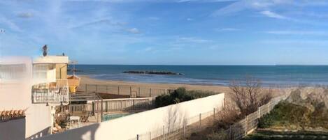 On the beach, sun-loungers