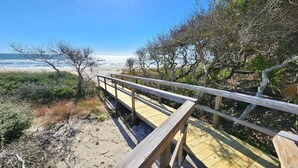 A wooden boardwalk leading to a beach with a clear view of the ocean. - Beachfront - Community Pool/Pickleball Access! (St. George Island)