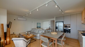 A modern apartment with a dining area, kitchen, and living room. - Greek Zen villa - stunning sea view -top of the hill in Athens Riviera (PWV6+C39 Saronida, Greece)