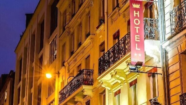 A hotel building with a prominent 'HOTEL' sign, ornate balconies, and classic architecture. - Hotel Riviera (Paris)
