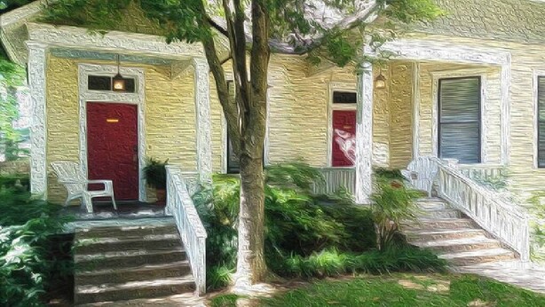 A two-story house with a red door, white railings, and a stone staircase leading to the front porch. - Barkley-Hayward Cottage (Little Rock)