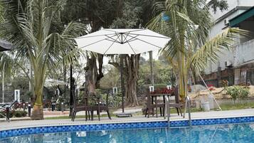 Outdoor pool, pool umbrellas, lifeguards on site