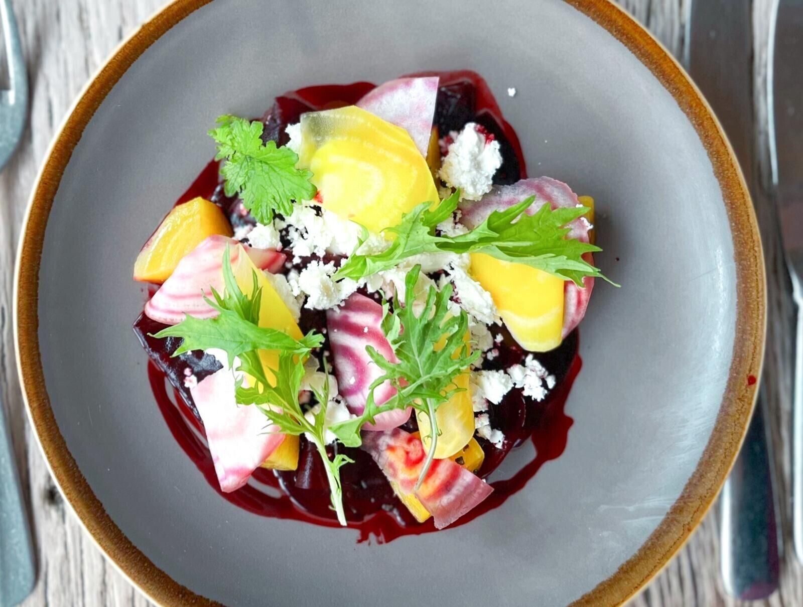 A plate of food with various fruits and cheese.