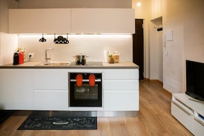 A modern kitchen with a built-in oven, a sink, and a countertop with various items. - Modern and comfortable house 30 meters from the Arena (Verona)