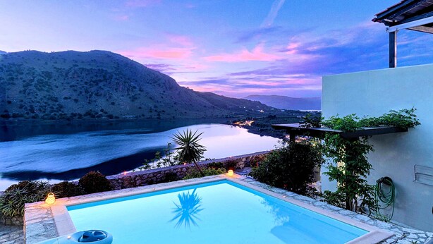A pool with a view of a lake and mountains at dusk. - Du Lac Villas 2 Private Pools (Kavallos)