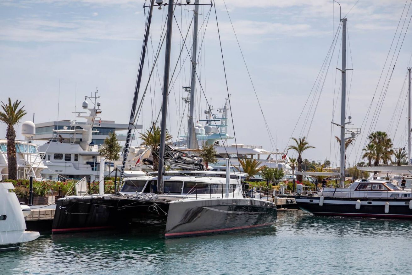 A marina with several yachts docked.