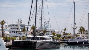 A marina with several yachts docked.