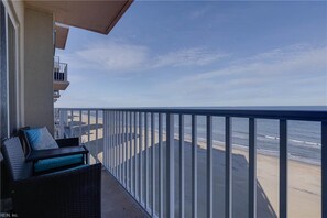 A balcony with a view of the beach and ocean. - Coastal Beach condo with indoor pool, ocean views, steps to the beach (Virginia Beach)