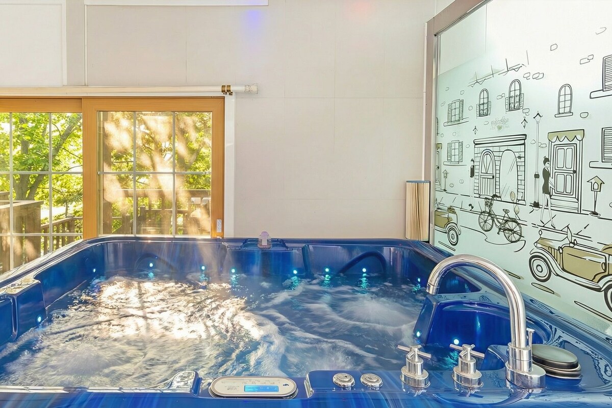 A hot tub with a digital control panel, a window with curtains, and a wall with a vintage car illustration.