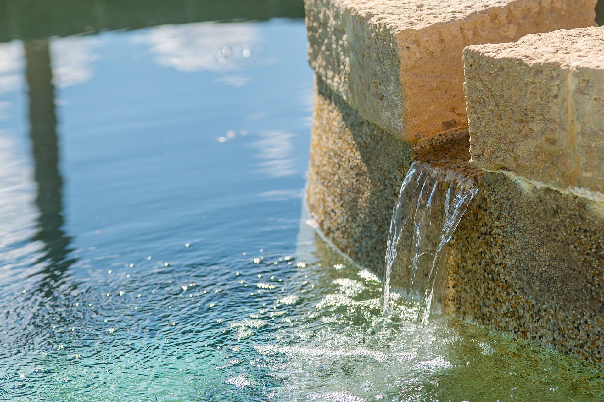 A water feature with a stone structure and flowing water.