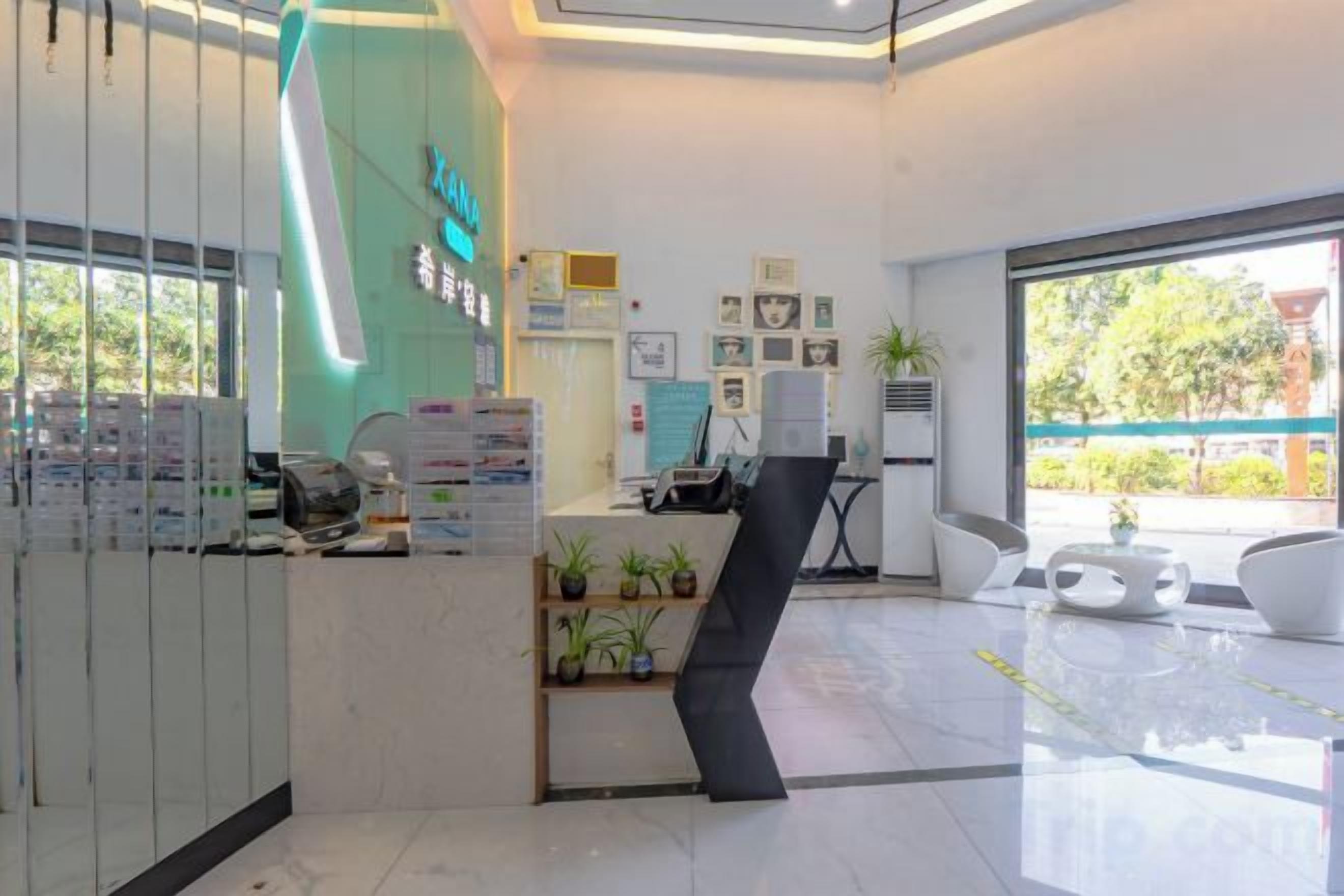 A reception area with a counter, a reception desk, and a seating area with chairs.