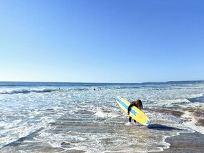 A beach with waves and a person holding a surfboard. - Only 4 miles from Westward Ho. (Littleham, near Bideford)