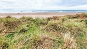 A beach with dunes and the ocean in the background. - Only 4 miles from Westward Ho. (Littleham, near Bideford)
