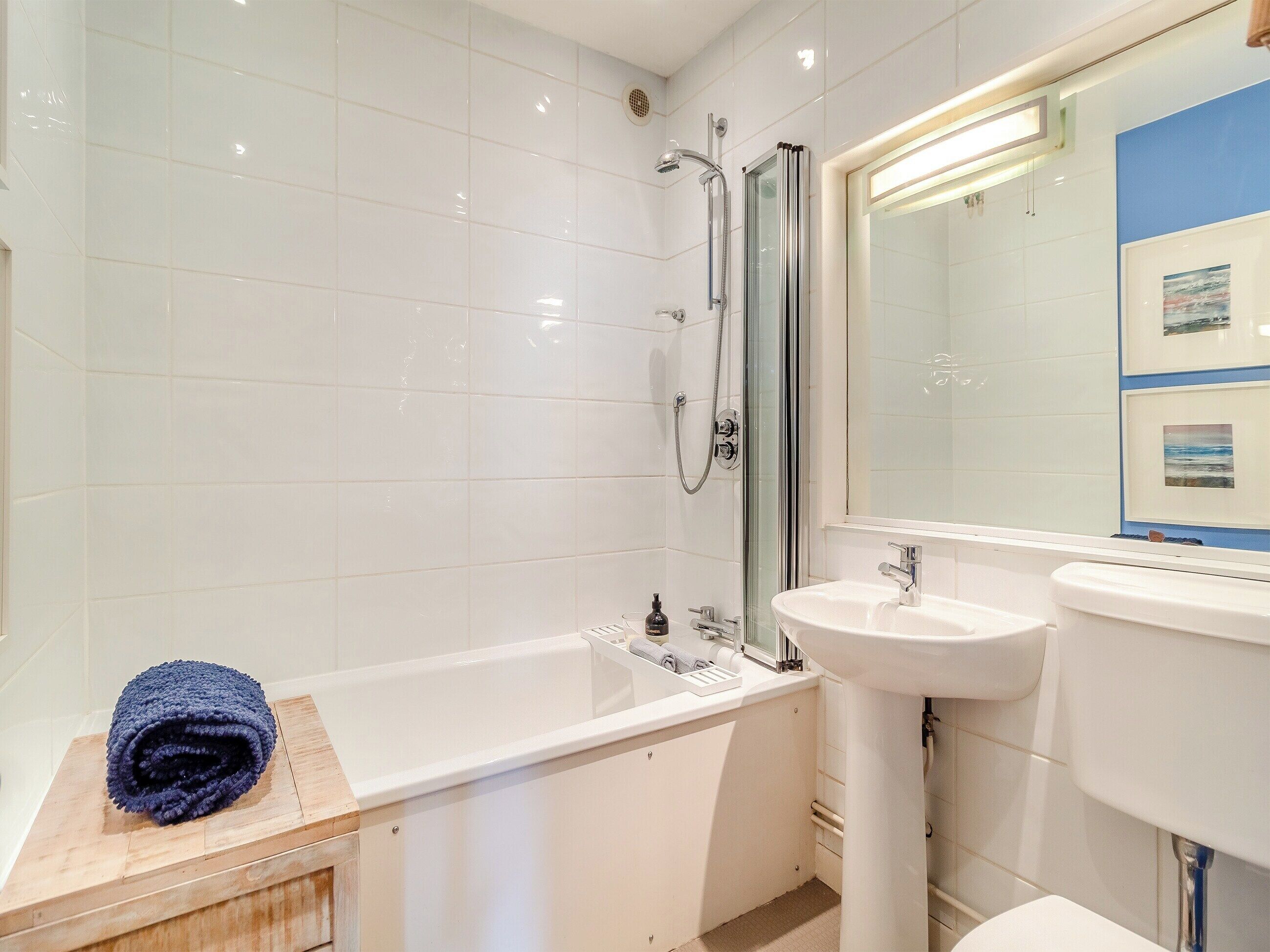 A modern bathroom with a bathtub, a sink, and a shower.