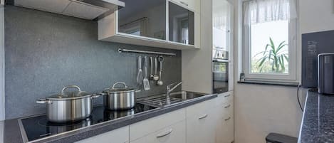 Family Apartment, Multiple Bedrooms (Sea Breeze Residence Mariella) | Private kitchen