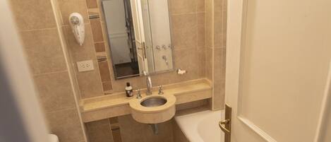 Un baño pequeño con inodoro, lavabo y bañera.