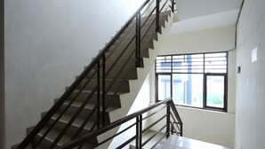 A staircase with a metal railing leading to a landing.