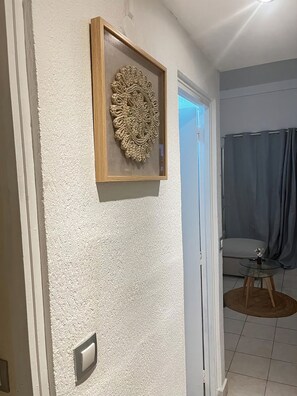 Cozy space with a framed decorative piece and a small table.