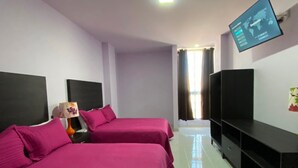 A hotel room with two beds, a TV mounted on the wall, and a TV stand. - Hotel Maricela (San Juan de los Lagos)