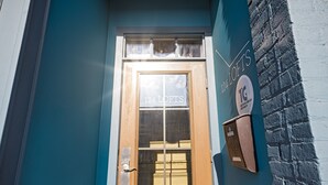 A teal building facade with a wooden door labeled '124 LOFTS' and a mailbox on the right. - 124 Lofts #2 - Downtown Dundee - Walk to Dining (West Dundee)