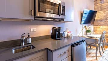 Fridge, microwave, coffee/tea maker, cookware/dishes/utensils