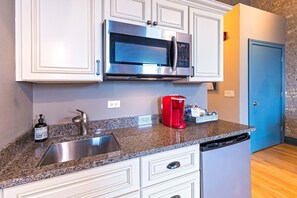 Fridge, microwave, coffee/tea maker, cookware/dishes/utensils