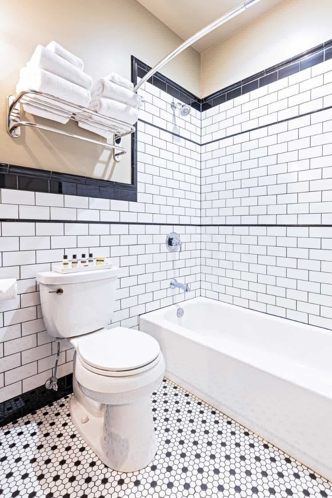 Bathtub, hair dryer, towels, shampoo