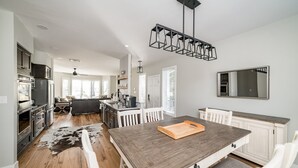 A spacious kitchen with a large island, white cabinetry, and a modern pendant light. - Beautiful 4-season Mountain Home- New Listing (Wintergreen Resort)