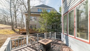 A deck with a table and chairs, a wooden bench, and a house in the background. - Beautiful 4-season Mountain Home- New Listing (Wintergreen Resort)