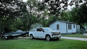 A white pickup truck parked in front of a house with a boat trailer. - Small Home in the City of Alexandria! (Alexandria)