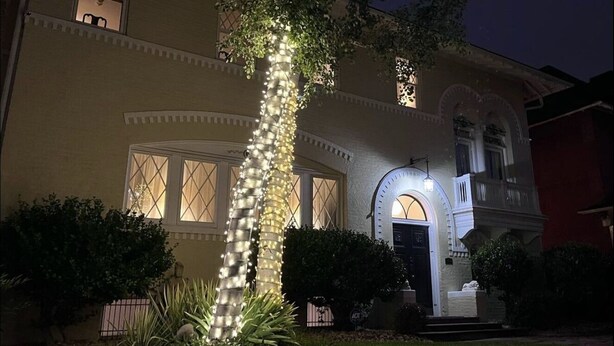 A two-story house with a symmetrical facade, a central entrance with an arched doorway, and a small porch area. - Elegant Garden-Level Apt, Beautiful Marble Spa Bath, City Center! 96 Walk Score! (Denver)