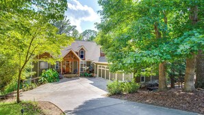 A two-story house with a front porch, a garage, and a driveway. - Lake Access: Waleska House w/ Floating Dock! (Waleska)