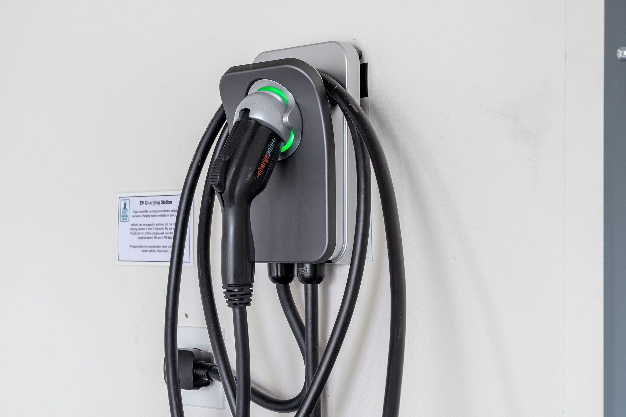 An EV charging station with a charging cable connected to a vehicle.