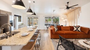 A modern kitchen with a central island, stainless steel appliances, and pendant lighting. - Alana House - Pool, Hot Tub, Bbq, Fire Pit + Walk To Hikes! 4 Bedroom Home by RedAwning (Joshua Tree)