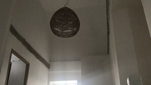 A room with a sloped ceiling, a window, and a hanging light fixture. - Renovated house with garage and 300 M2 of land,  (Condé-sur-Sarthe)
