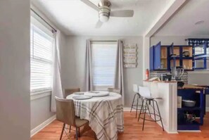 Cozy dining area for four, complete with a round table and comfortable seating.