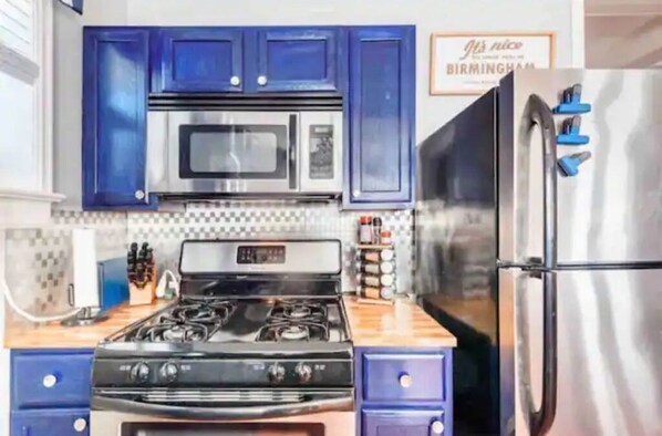 Enjoy cooking in this fully equipped kitchen with a gas stove, microwave, and refrigerator.