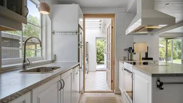 Fridge, stovetop, dishwasher, coffee/tea maker