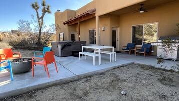 Enjoy al fresco dining on the patio, equipped with a barbecue grill, table, and comfortable seating.